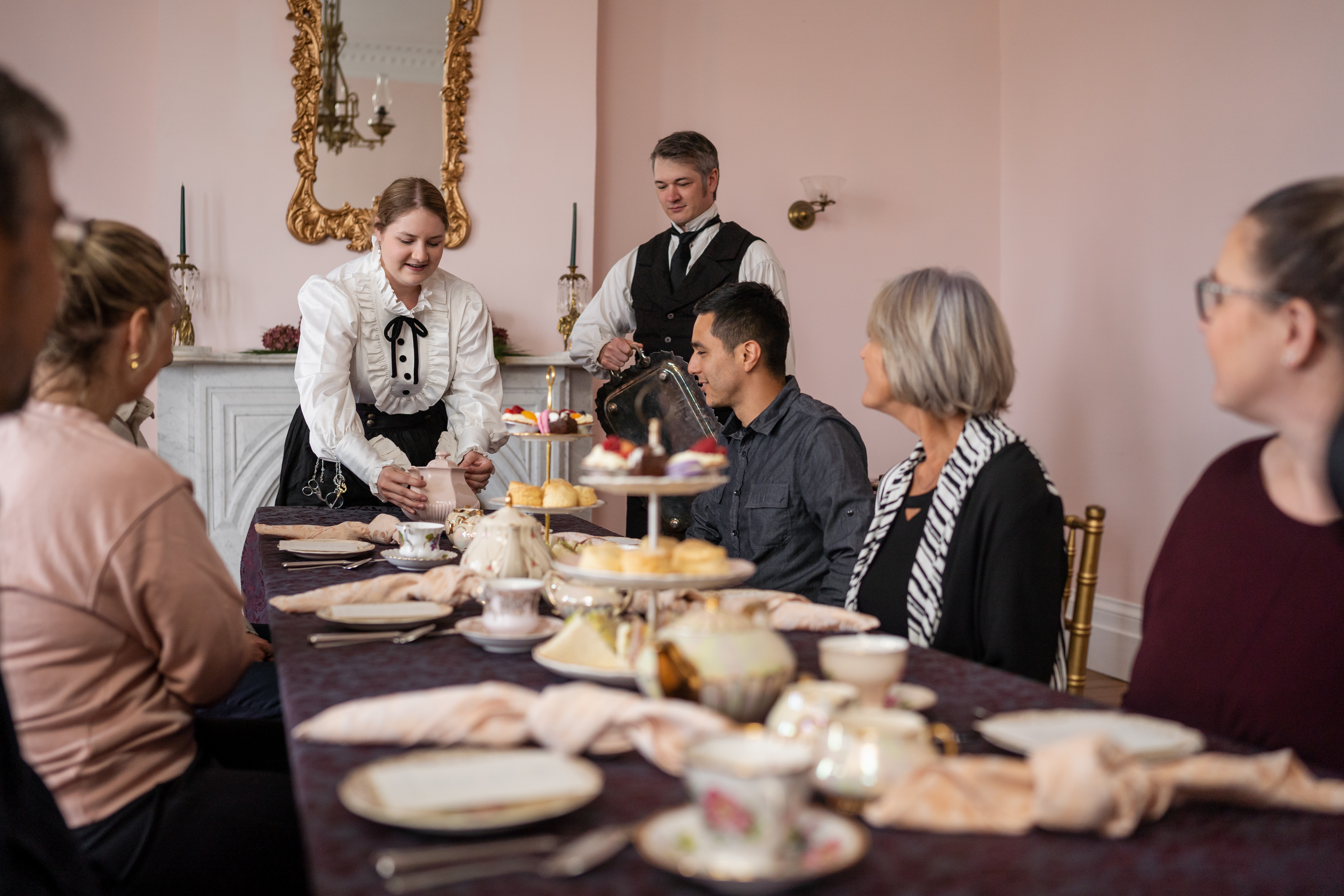 a group of guests is served high tea 